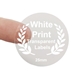 Round transparent label with white print reading 25mm, held between two fingers. Features a laurel wreath design and is ideal for customised or personalised branding on small product packaging or gift items.