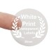 transparent sticker on a finger to show size of label with white print