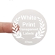 Round transparent label with white print reading 37mm, held between two fingers. Features a laurel wreath design and is ideal for customised or personalised branding on small product packaging or gift items.