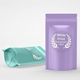 Two stand-up pouches, one in lavender and one in mint green, each featuring a round transparent label with white print and laurel wreath design. Ideal for customised or personalised branding on food, supplements or beauty packaging.