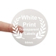 Round transparent label with white print reading 64mm, held between two fingers. Features a laurel wreath design and is ideal for customised or personalised branding on small product packaging or gift items.
