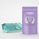 Two stand-up pouches, one in lavender and one in mint green, each featuring a round transparent label with white print and laurel wreath design. Ideal for customised or personalised branding on food, supplements or beauty packaging.
