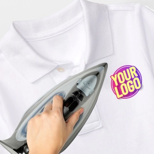 Hand ironing a custom heat transfer logo onto a white polo shirt, showcasing a vibrant design labelled Your Logo. Ideal for personalised branding or creating customised clothing with ease.