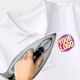 Hand ironing a custom heat transfer logo onto a white polo shirt, showcasing a vibrant design labelled Your Logo. Ideal for personalised branding or creating customised clothing with ease.