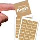 Close-up of a hand holding a square kraft label with white print reading White Print Kraft Labels above two sheets of matching stickers. The labels have a striped brown texture and are arranged neatly on white backing sheets, ideal for customised branding.