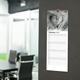 a slim calendar hanging on the wall of an office