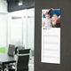 Slim personalised photo kitchen calendar displayed on a wall with individual writing lines for each day.