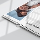 Close-up view of a 2026 wall planner calendar laid flat, showing a metal hanging hook and wire binding. The calendar features a joyful photo of a young girl playfully covering a man's eyes while sitting on his shoulders, with a clear blue sky in the background.