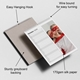 Wall planner calendar open to October 2026, featuring a fun photo of two children in red superhero costumes. The calendar highlights key features with labels: easy hanging hook, wire bound for easy turning, sturdy greyboard backing, and 170gsm silk paper.