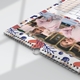 Close-up of a colourful wall calendar lying flat, showing a young girl in a pink jacket printed upside down on a decorative page with abstract leaf and swirl patterns. The wire binding and central hanging hook are prominently visible, highlighting the calendar’s build quality and design details.