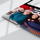 Close-up of a wire-bound personalised A3 calendar featuring a smiling family in Christmas clothing.