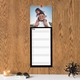 Black personalised photo kitchen planner displayed on a wooden wall with lined daily writing spaces.