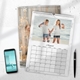 Personalised A4 August photo calendar displayed on a desk with two girls, a smartphone and a pen.