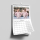 Personalised A4 wall calendar displaying a February monthly grid and a photo of two girls beside a carousel.