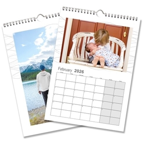 Two personalised wall calendar pages for February 2026. One page features a young child gently holding a baby on a rustic white bench, while the other displays a scenic landscape of a man walking beside a lake with snow-capped mountains in the background. Both calendars have spiral binding and clean, white borders.