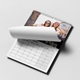 October 2026 wall calendar laid flat on a white surface, with the top page being flipped to reveal a cheerful photo of two young women wearing sunglasses and smiling outdoors in an urban setting. The calendar features a clean grid layout with clear day and date markings.