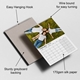 Wall calendar featuring a photo of a smiling family lying on grass, with key features labelled: easy hanging hook, wire-bound spine for smooth page turning, sturdy greyboard backing for durability, and 170gsm silk paper for a quality finish. The visible calendar page displays February 2026.