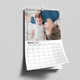 Personalised A3 wall calendar displaying March 2027 with a photograph of a parent lying beside a baby.