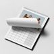 Open personalised A3 photo calendar with a page turning over a monthly date grid.