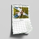 A 2026 wall calendar is displayed open to February, hanging on a light grey wall. The page features a photo of a family lying on green grass in matching white tops and jeans, smiling up at the camera. The calendar has a soft green leaf border and a clean, minimal layout with clearly marked dates. Spiral-bound with a central hanging hook, it offers a fresh and modern design.