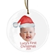 Personalised ceramic Christmas bauble featuring a baby’s smiling face wearing a festive Santa hat. Below the image, the text reads 