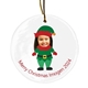 Personalised ceramic Christmas bauble featuring a child's smiling face on an elf body dressed in a green and red outfit with a matching hat. The text below reads 