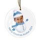 Personalised ceramic Christmas bauble featuring a child's smiling face on a snowman body wearing a blue hat and scarf. The text around the bottom reads 