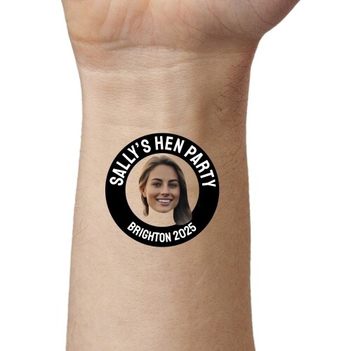 Close-up of an arm displaying a custom temporary tattoo featuring a woman's face in a black circle with the text 