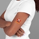 A woman in a white T-shirt with crossed arms displays a red star-shaped temporary tattoo on her upper arm. The tattoo features a man's face and the words Happy Birthday! in bold text, adding a festive touch.