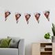 ersonalised baby photo bunting hanging in a modern living room, featuring triangular flags with a sleeping newborn image, strung across a neutral wall above a sofa and cabinet with potted plants.