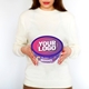 Person holding a purple Cadbury Heroes tub featuring a customisable circular sticker on the lid with the text Your Logo in bold white font on a purple gradient background. Ideal for personalised branding or festive gifts.