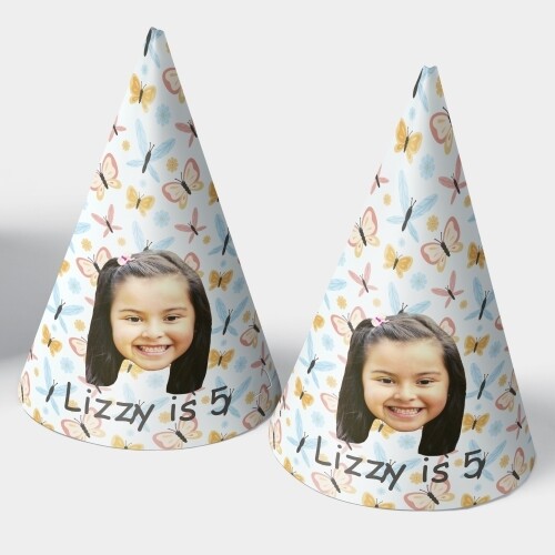 Two customised party hats with a white background, personalised with your photo and number of your choice. The hats are displayed upright side by side. Perfect for birthdays or celebrations.