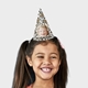 Smiling girl wearing a customised party hat with your own face and number. The girl has pigtails and is laughing, showcasing the fun design. Ideal for birthdays or themed celebrations.