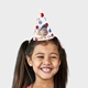 Smiling girl wearing a customised party hat with your own face and number. The girl has pigtails and is laughing, showcasing the fun design. Ideal for birthdays or themed celebrations.