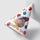 Customised party hat, the number a number of your choice,personalised with your photo. The hat is propped against a smooth white surface. Ideal for birthdays or celebrations.