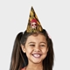 Smiling girl wearing a customised party hat with your own face and number. The girl has pigtails and is laughing, showcasing the fun design. Ideal for birthdays or themed celebrations.