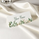 Personalised wedding place card with your name in elegant design on folded white cardstock. Set on a softly draped ivory tablecloth, creating a sophisticated and timeless look.