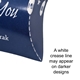 Close-up of a dark blue personalised pillow box with a printed white design, showing a visible white crease line along the fold. A note on the image states that a white crease line may appear on darker designs.