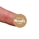 A small round personalised Kraft label with white print, shown on the tip of a finger for scale. The brown sticker features a subtle vertical stripe texture and the words White Print Kraft Labels in bold, white text. Ideal for custom or customised packaging and product branding.