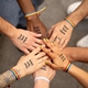 Group wearing personalised text temporary tattoos at an event