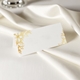 wedding place card in elegant design printed on folded white cardstock ready for you to write your names. Set on a softly draped ivory tablecloth, creating a sophisticated and timeless look.