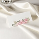 wedding place card in elegant design printed on folded white cardstock ready for you to write your names. Set on a softly draped ivory tablecloth, creating a sophisticated and timeless look.