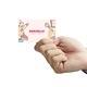 a hand holding a laminated business card