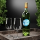 Green wine bottle with a customised circular blue and white logo reading Your Logo, placed on a marble tray with two empty wine glasses. Decorative greenery frames the background. Ideal for personalised branding or gifting.