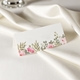 wedding place card in elegant design printed on folded white cardstock ready for you to write your names. Set on a softly draped ivory tablecloth, creating a sophisticated and timeless look.