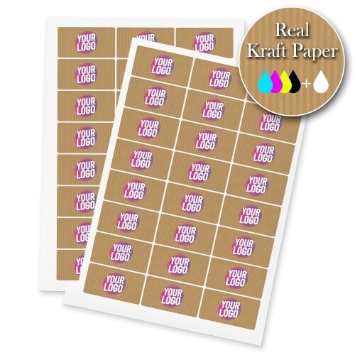 Sheets of rectangular kraft labels printed with a personalised design featuring the text Your Logo in bold pink and white on a brown kraft paper background. A badge in the corner highlights Real Kraft Paper with colour printing options.