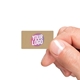 Kraft Rectang;e label sticker with a custom purple and white logo, shown in a hand. The natural brown background of the label gives a rustic and eco-friendly appearance, ideal for personalised packaging