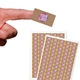 Close-up of a hand holding a rectangle custom sticker with bold text in pink, white, and yellow on a kraft background. Two sheets of identical stickers are displayed below. Perfect for personalised labelling and branding.