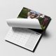 A 2025 A4 photo calendar, partially open to reveal a blank monthly grid. The top image shows a smiling child being held by the arms in an outdoor setting. The calendar is spiral-bound, with a simple design for easy page turning.