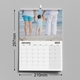 A 2025 A4 photo calendar measuring 297mm by 210mm. The displayed month is January, featuring a family standing on the beach, holding a child's hands. The calendar is spiral-bound with a hanging hook and has a spacious monthly grid for notes and events.